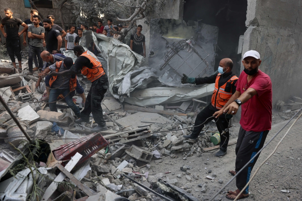 EDITORS NOTE: Graphic content / Rescuers search for victims or survivers under the rubble of a house destroyed in an Israeli strike on Rafah in the southern Gaza Strip on October 22, 2023 amid the ongoing battles between Israel and the Palestinian group. (Photo by SAID KHATIB / AFP)

