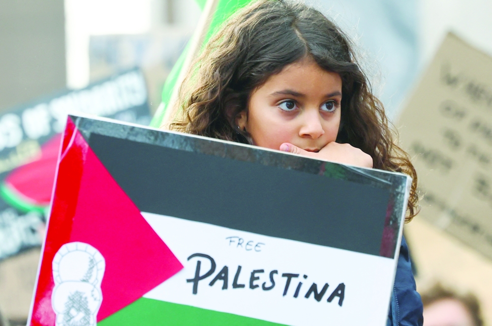A girl looks on during a protest in support of Palestinians, outside the European Commission headquarters in Brussels, Belgium, on Sunday. — Reuters