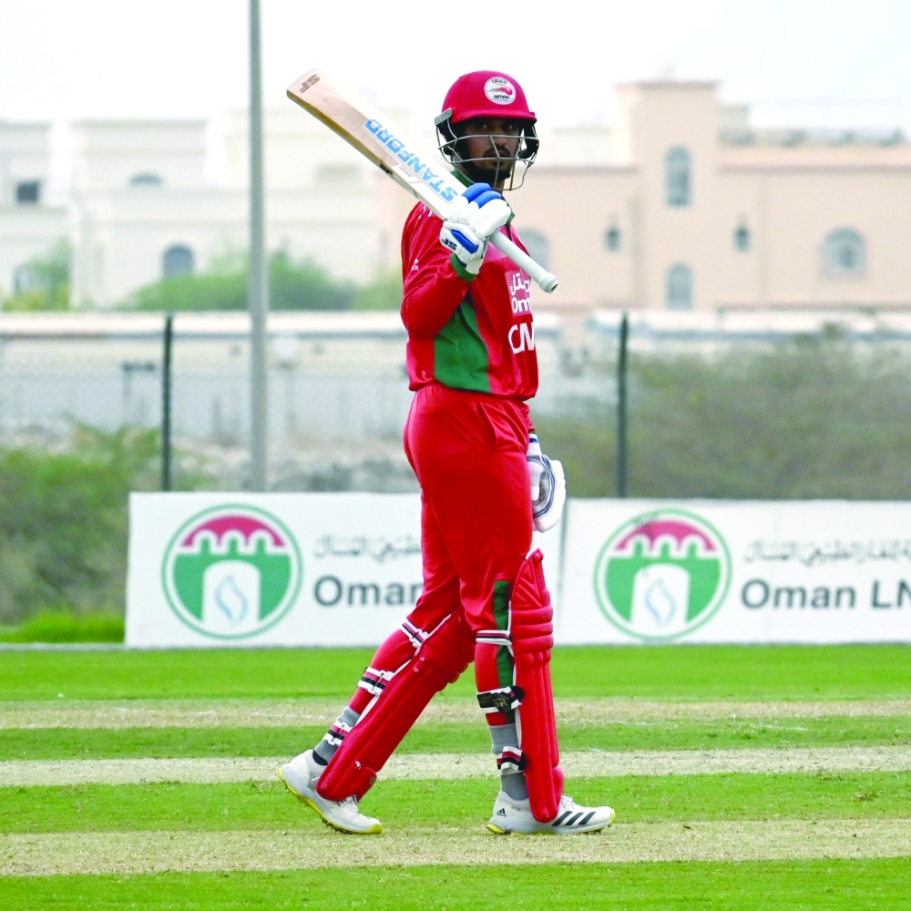 Oman team player, Aaqib Ilyas in action 