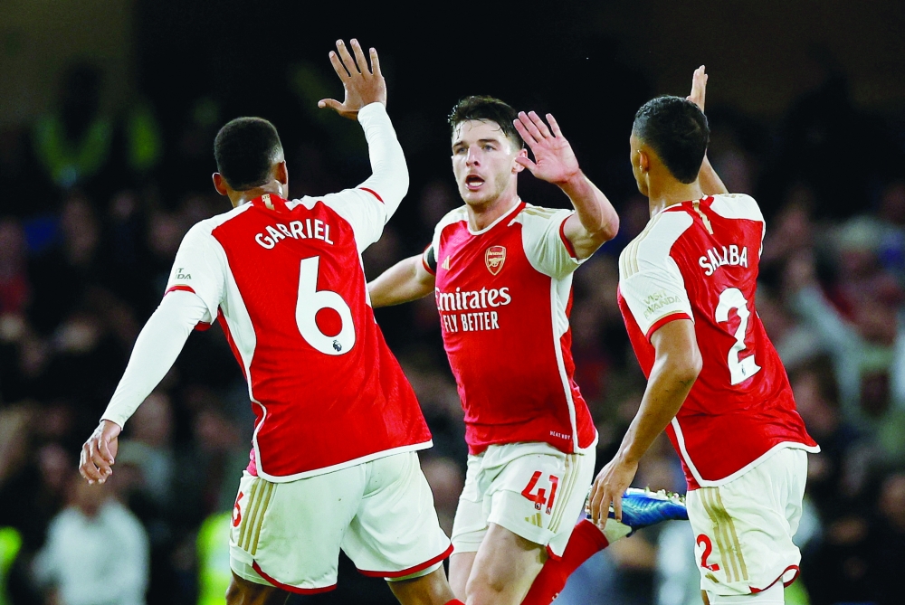 Arsenal's Declan Rice celebrates scoring their first goal with Gabriel and William Saliba.—Reuters