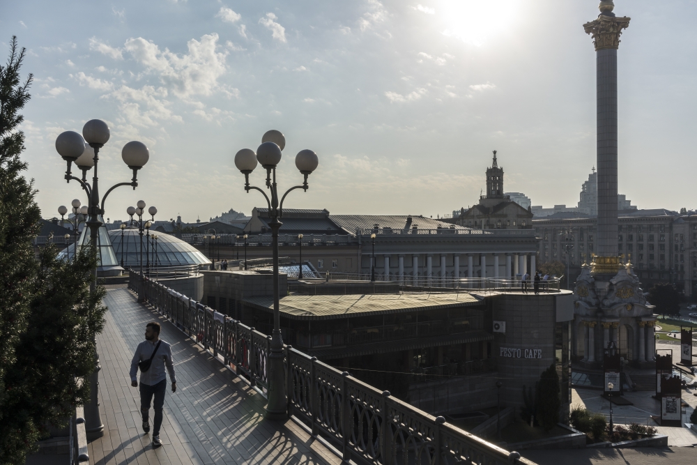 A man crosses a foot bridge near Independence Square in Kyiv, Ukraine. — The New York Times
