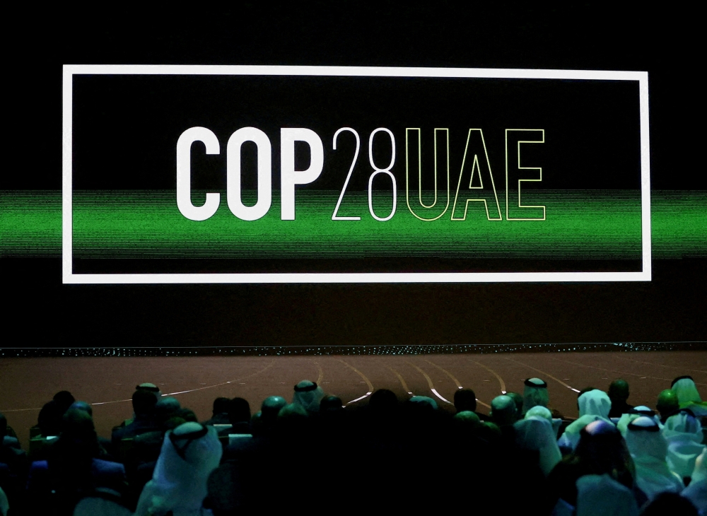 FILE PHOTO: 'Cop28 UAE' logo is displayed on the screen during the opening ceremony of Abu Dhabi Sustainability Week (ADSW) under the theme of 'United on Climate Action Toward COP28', in Abu Dhabi, UAE, January 16, 2023. REUTERS/Rula Rouhana/File Photo