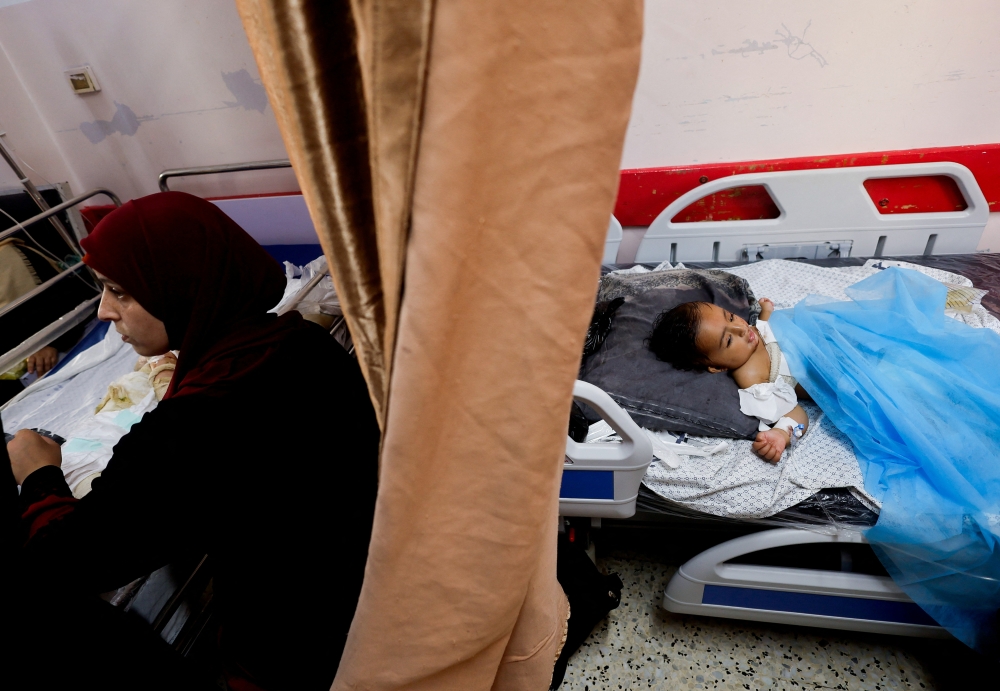 Wateen, a 14 months old Palestinian who was injured in an Israeli strike which killed her mother and injured her twin brother Ahmed, rests at Nasser hospital, in Khan Younis, in the southern Gaza Strip, October 23, 2023