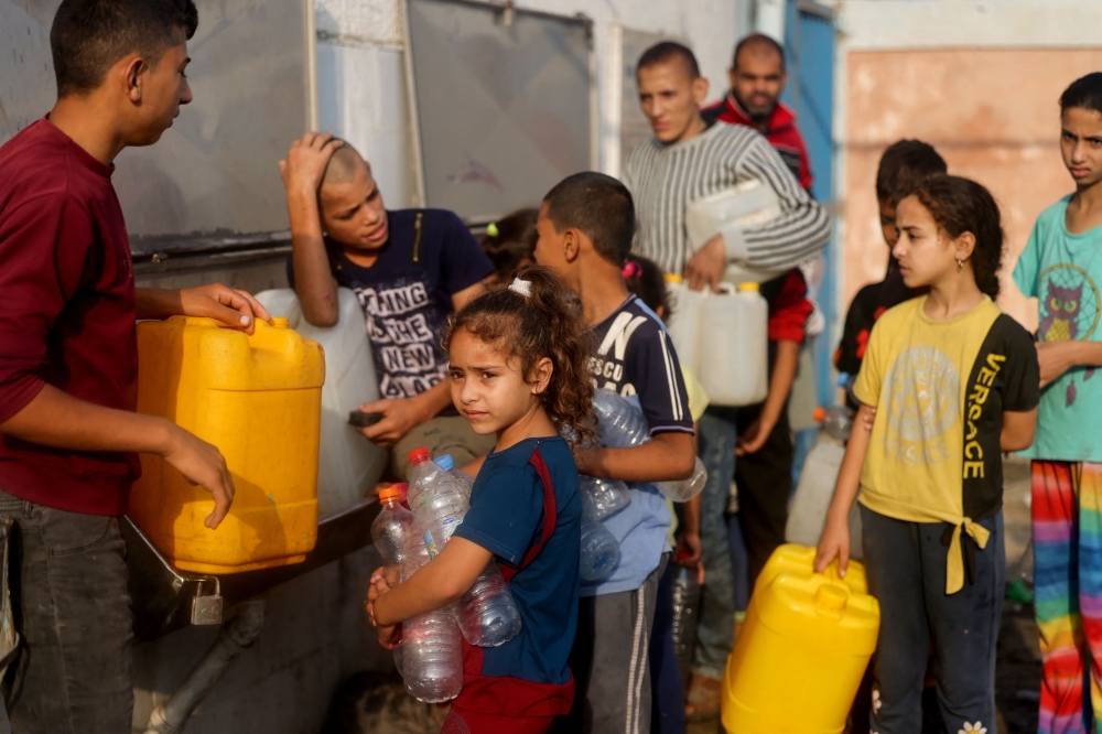 Palestinians line up to refil their water containers in Rafah on the southern Gaza Strip. — AFP 