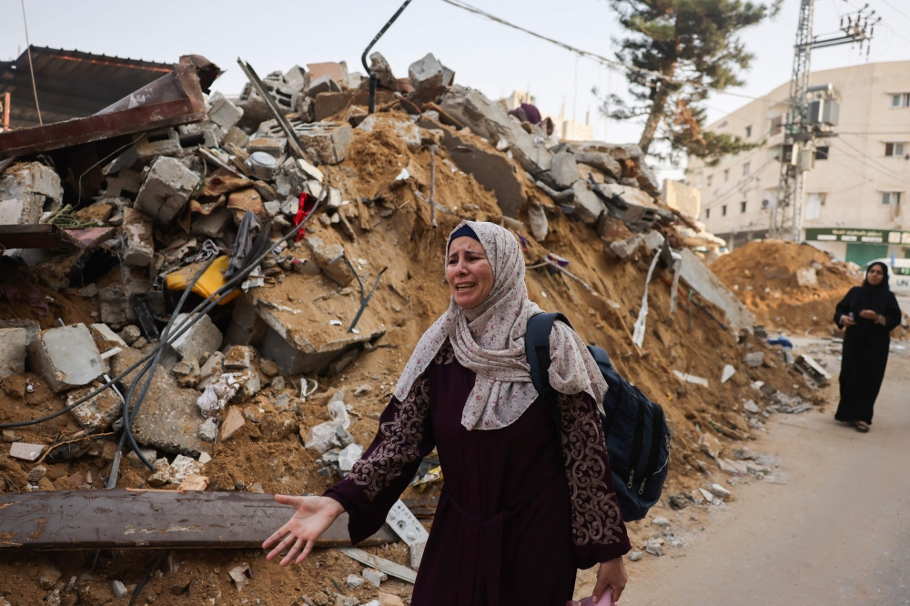 A woman reacts next to the rubble of a building following Israeli strikes on Rafah in the southern Gaza Strip. — AFP 