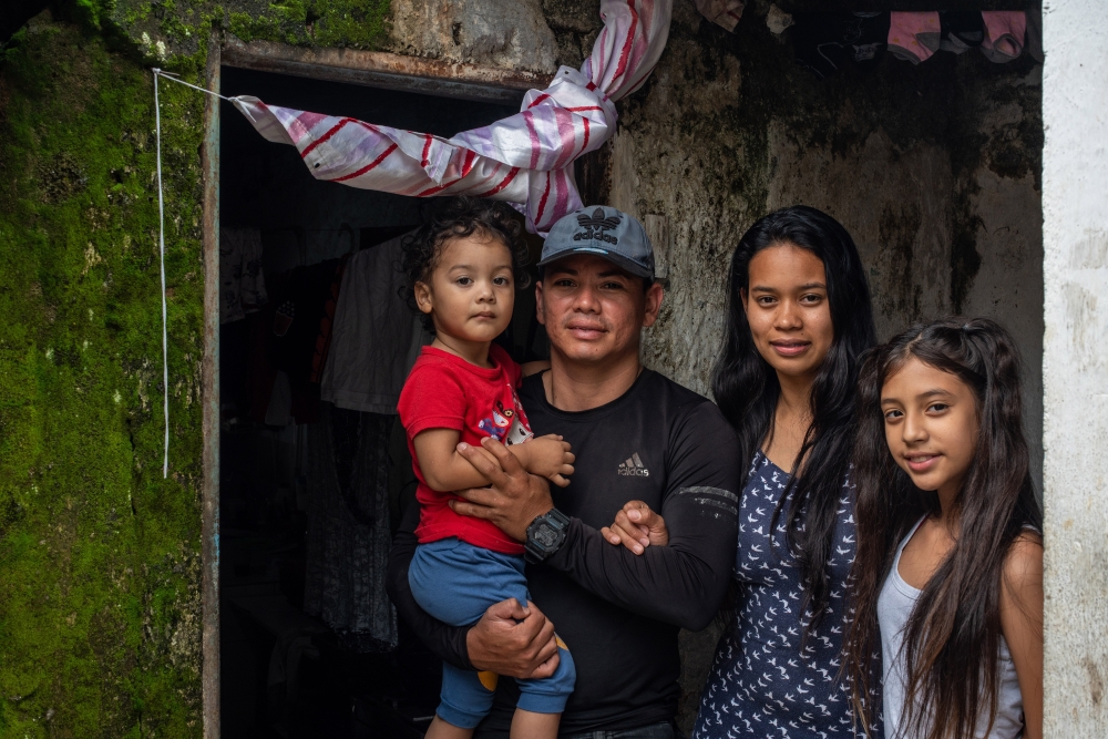 Marlon Victoria, a volunteer with the World Mosquito Program, which helps to protect communities around the world from mosquito-borne diseases, with his family in the Siloe neighborhood of Cali, Colombia, Jan. 18, 2023. (Federico Rios/The New York Times)