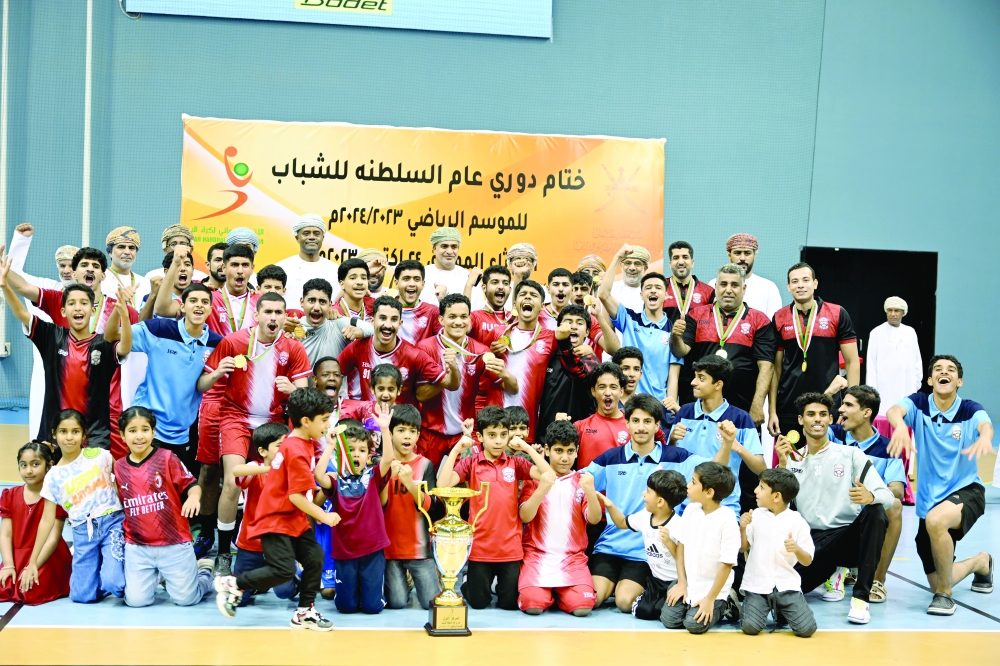 Muscat players celebrate with the trophy. -- Khalfan al Ruzaiqi