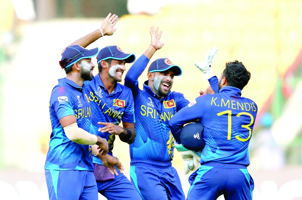 Sri Lanka's Kusal Mendis celebrates with teammates after taking the wicket of England's Adil Rashid REUTERS