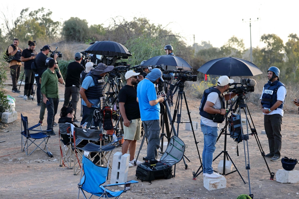 Members of the media gather at a spot overlooking the Gaza Strip in the southern Israeli city of Sderot amid ongoing battles between Israel and the Hamas. - AFP