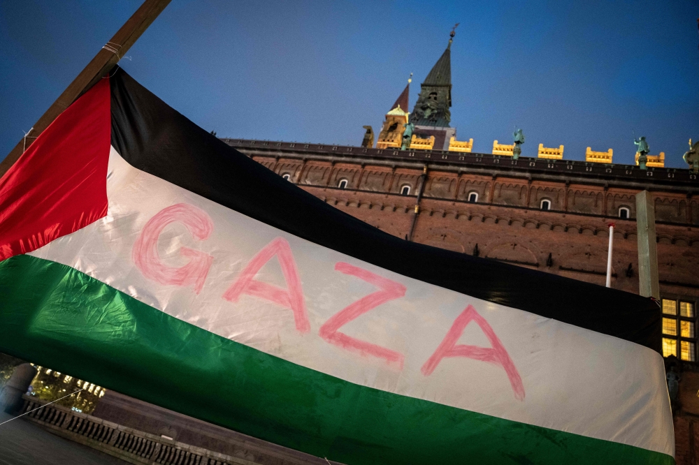 A Palestinian flag with the inscription "Gaza" flutters during a memorial service under the motto "children pay the price"