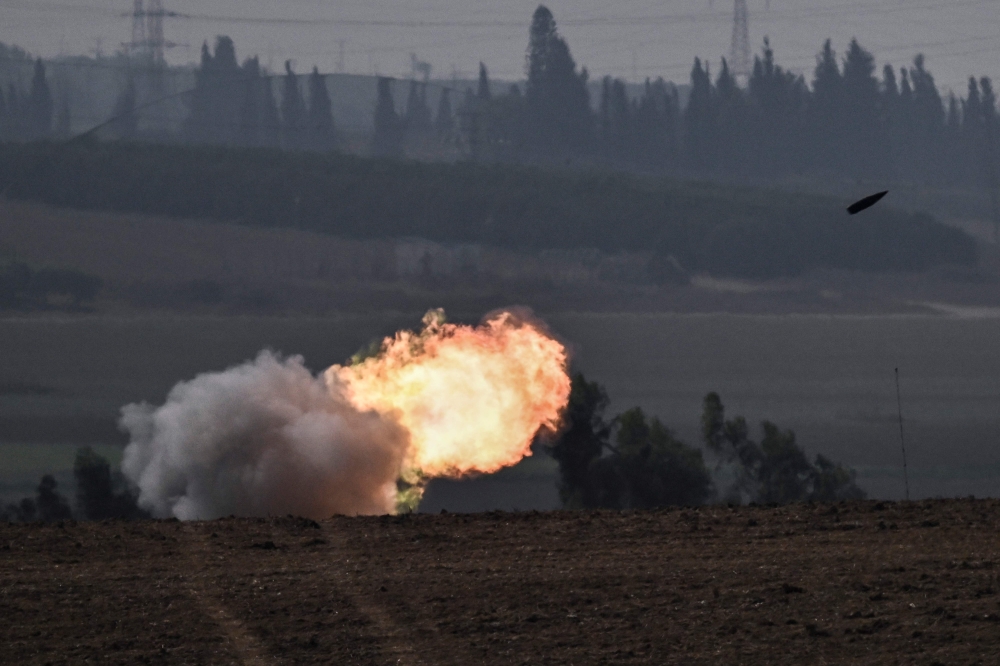 The Israeli military fires shells toward the Gaza Strip. — AFP 
