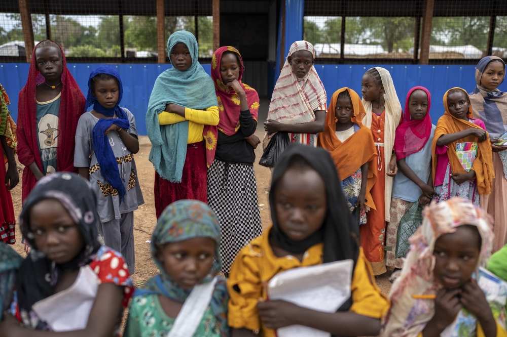 Students gathering outside makeshift classrooms at an aid camp in Aweil, South Sudan.