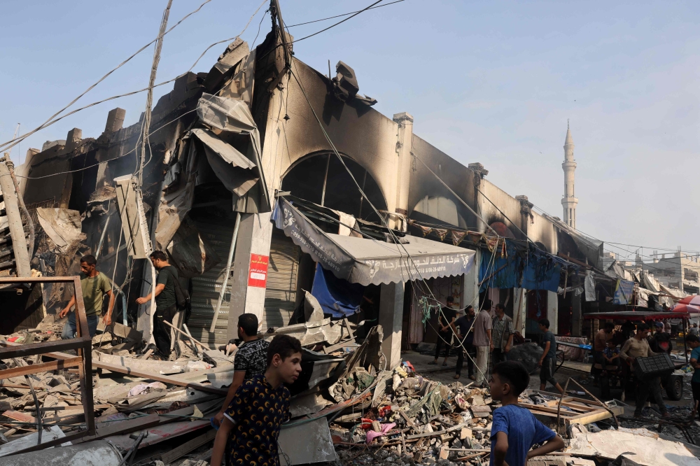 People check the destruction following Israeli strikes on Al-Shatee camp in Gaza City on on Saturday. — AFP