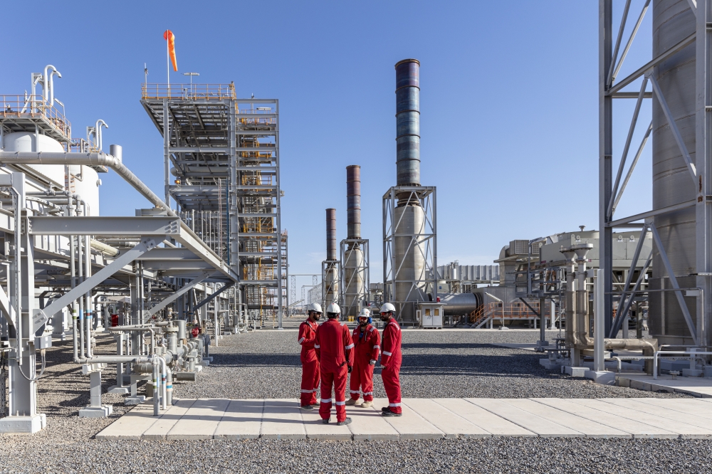 Employees are seen at an oil processing plant in Oman.