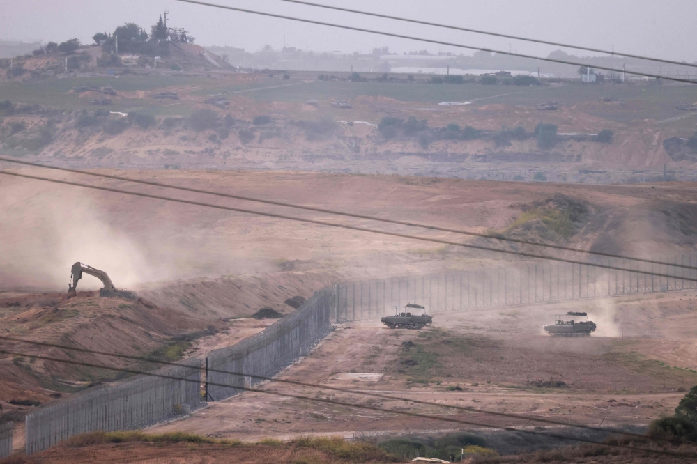 A picture shows Israeli army bulldozers and tanks crossing the border into Gaza
