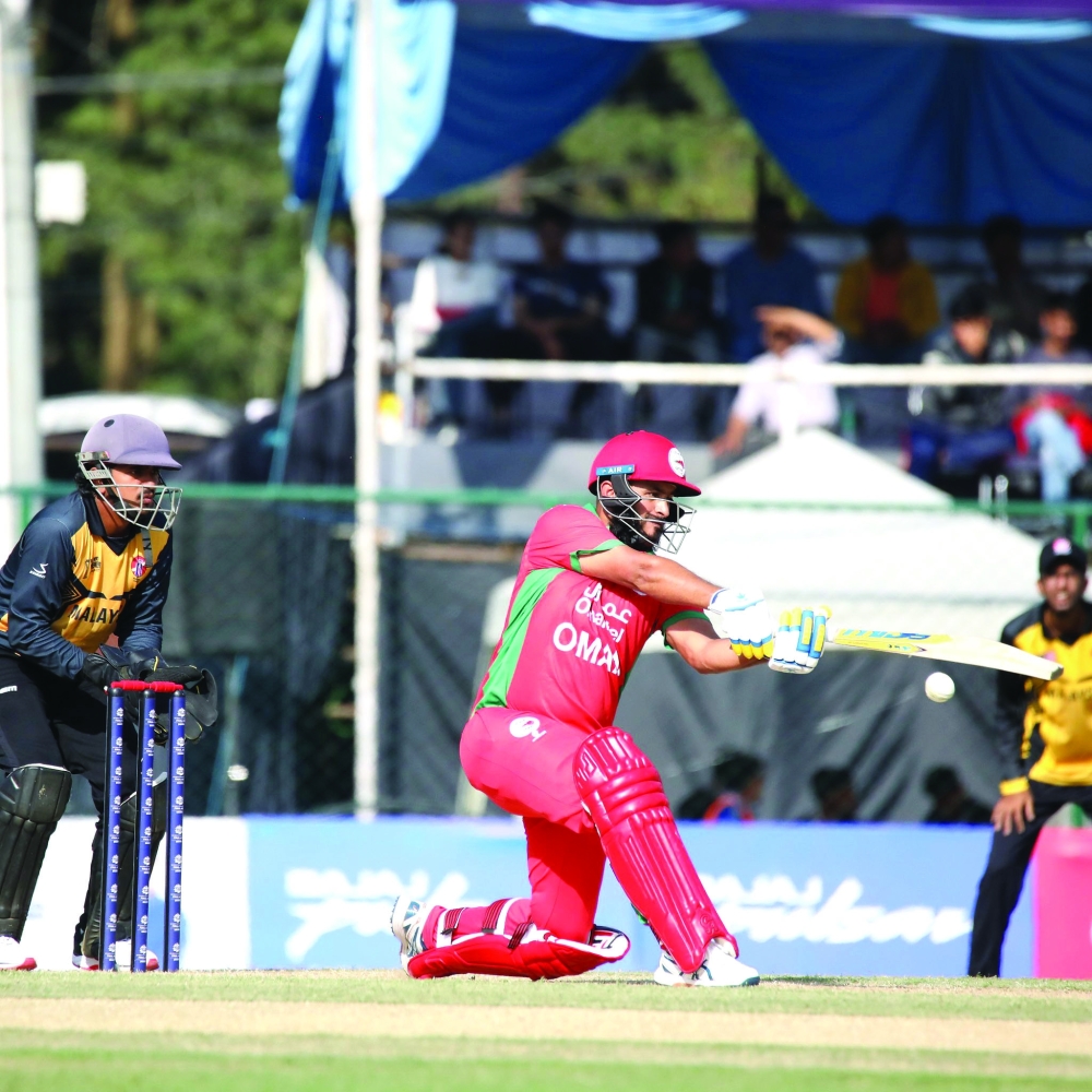 Oman captain Zeeshan Maqsood plays a shot.