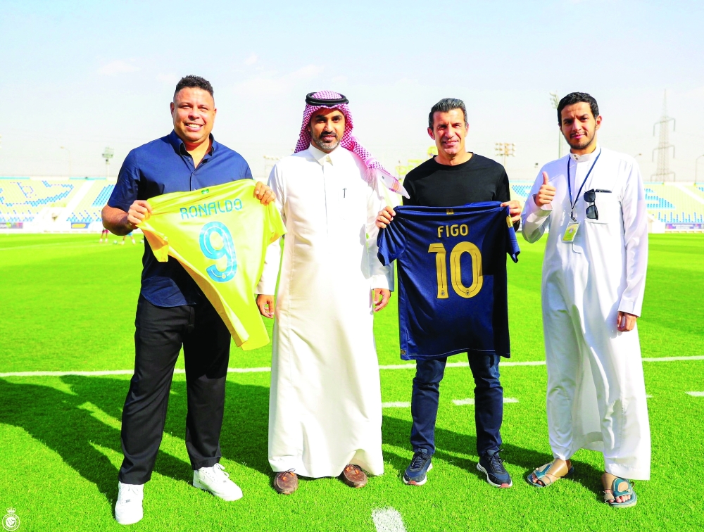 Former players Ronaldo and Luis Figo pose with officials during their visit to Al Nassr's KSU Stadium in Riyadh, Saudi Arabia. -- Reuters