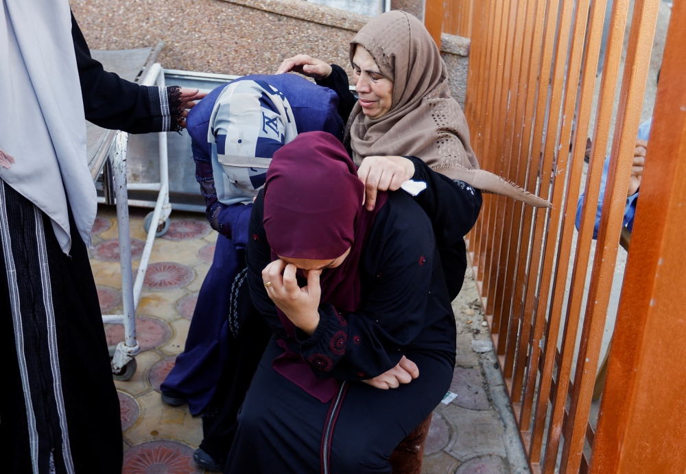 Mourners react during a funeral of Palestinians killed in Israeli strikes, in Khan Younis in the southern Gaza Strip. — Reuters 