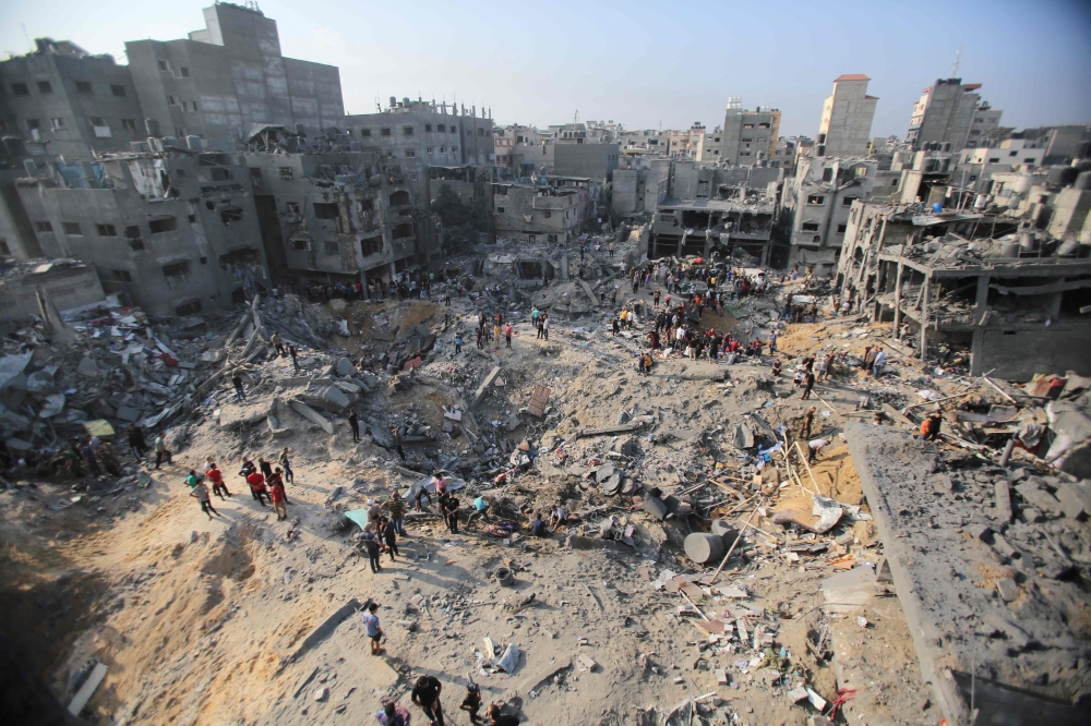 Palestinians check the destruction in the aftermath of an Israeli strike in the Jabalia camp for Palestinian refugees in the Gaza Strip, on November 1, 2023, amid ongoing battles between Israel and the Palestinian Hamas movement. (Photo by Bashar TALEB / AFP)

