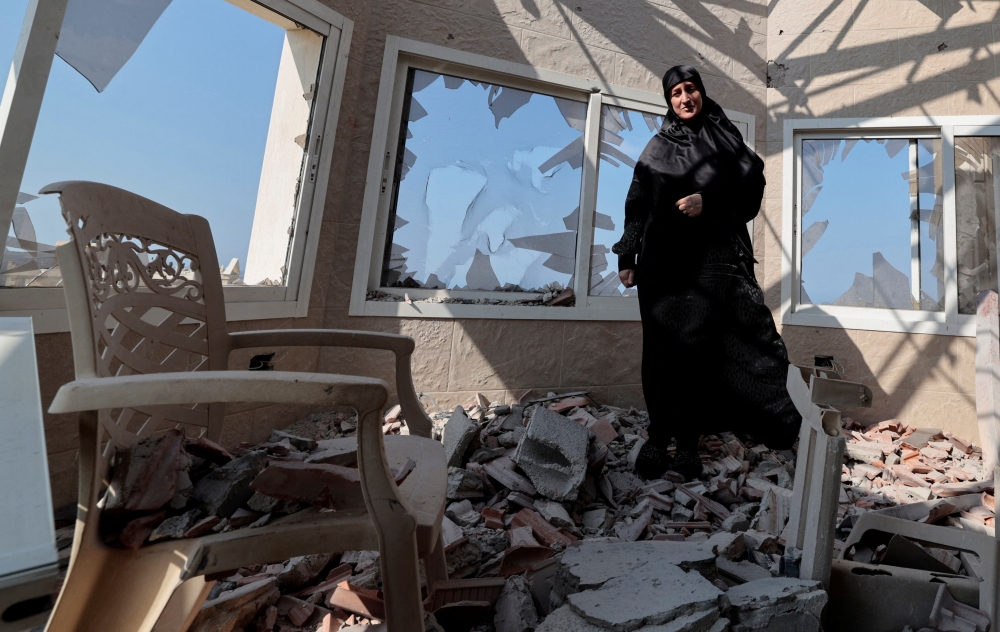 Chadia Kaddouh, looks on as she shows her house that was destroyed by what she said was an Israeli drone attack, amidst tension between Israel and Hezbollah, in Yater, on Wednesday. — Reuters