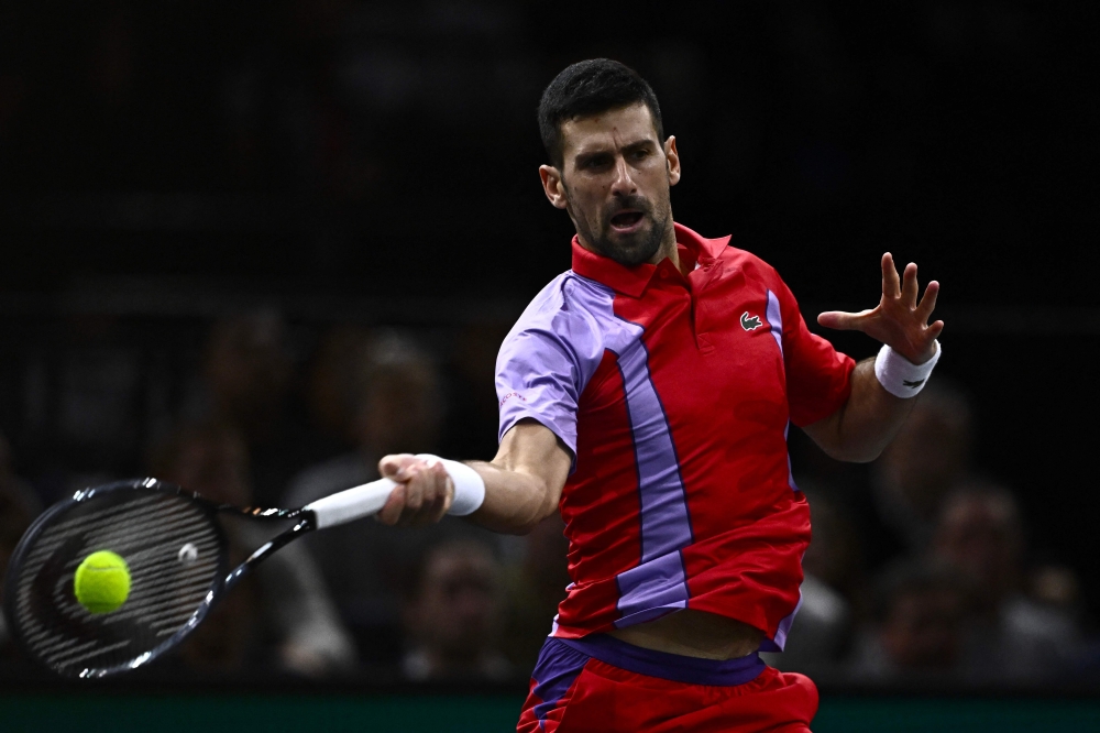 TOPSHOT - Serbia's Novak Djokovic plays a forehand return to Netherlands' Tallon Griekspoor during their men's singles match on day four of the Paris ATP Masters 1000 tennis tournament at the Accor Arena - Palais Omnisports de Paris-Bercy - in Paris on November 2, 2023.  (Photo by JULIEN DE ROSA / AFP)