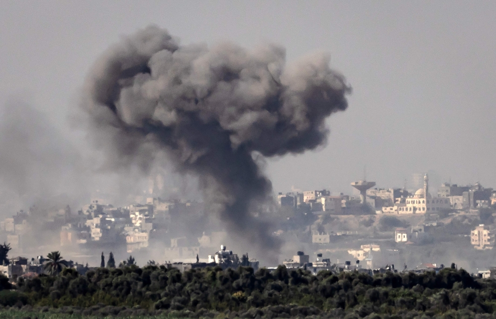 A picture taken from the Israeli side of the border with the Gaza Strip shows Israeli bombardment in the Gaza Strip. - AFP

