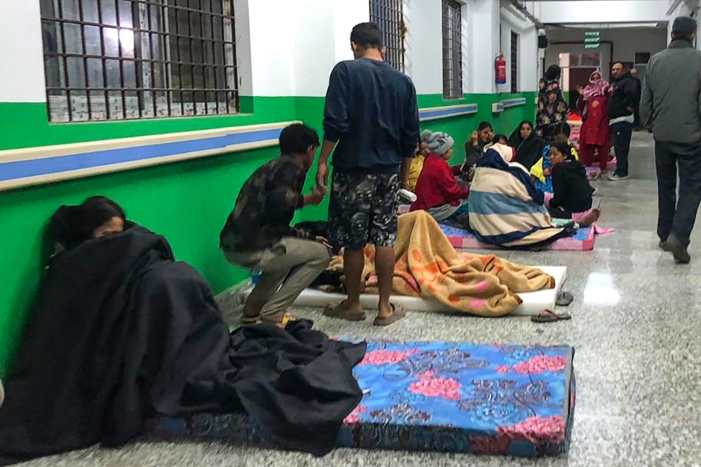 Survivors are seen in a corridor of the Jajarkot district hospital in the aftermath of an earthquake in Jajarkot 