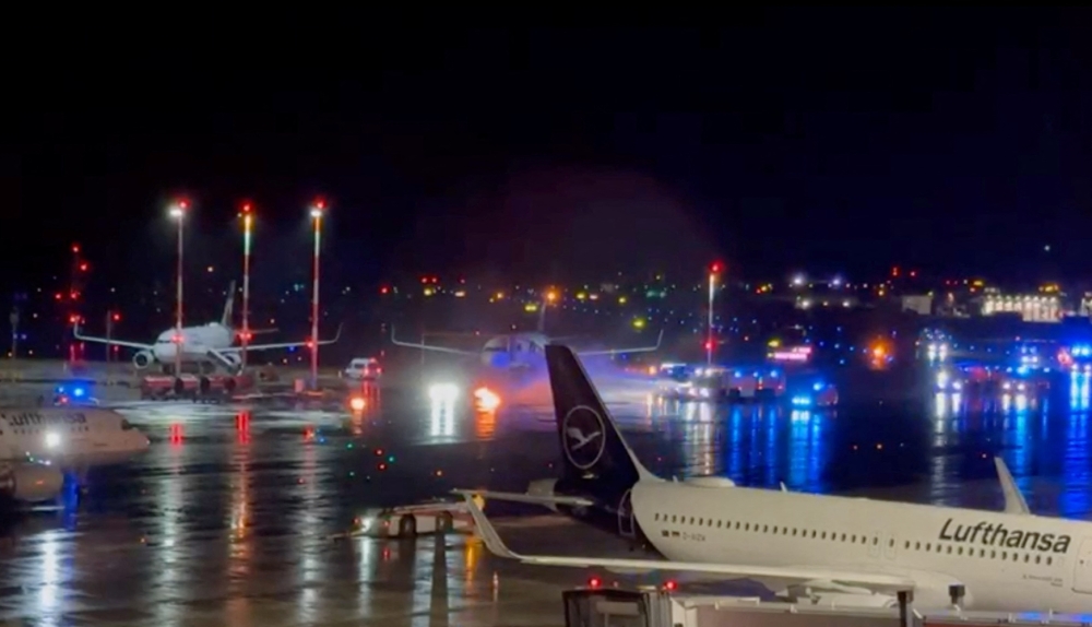 Fire engines put out small fires on the tarmac of Hamburg Airport i