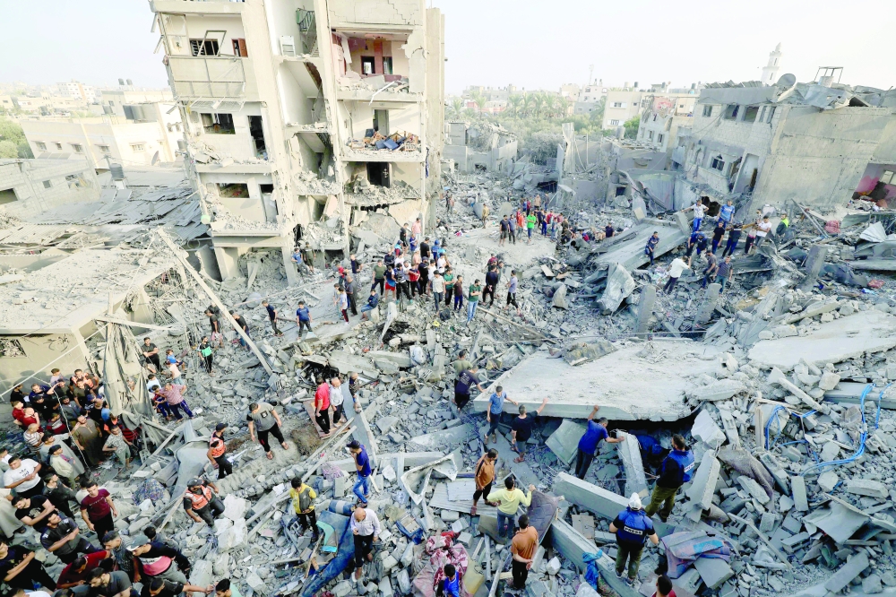 People check the damage caused by an Israeli strike on the Al-Maghazi refugee camp in Deir Balah in the central Gaza Strip. — AFP