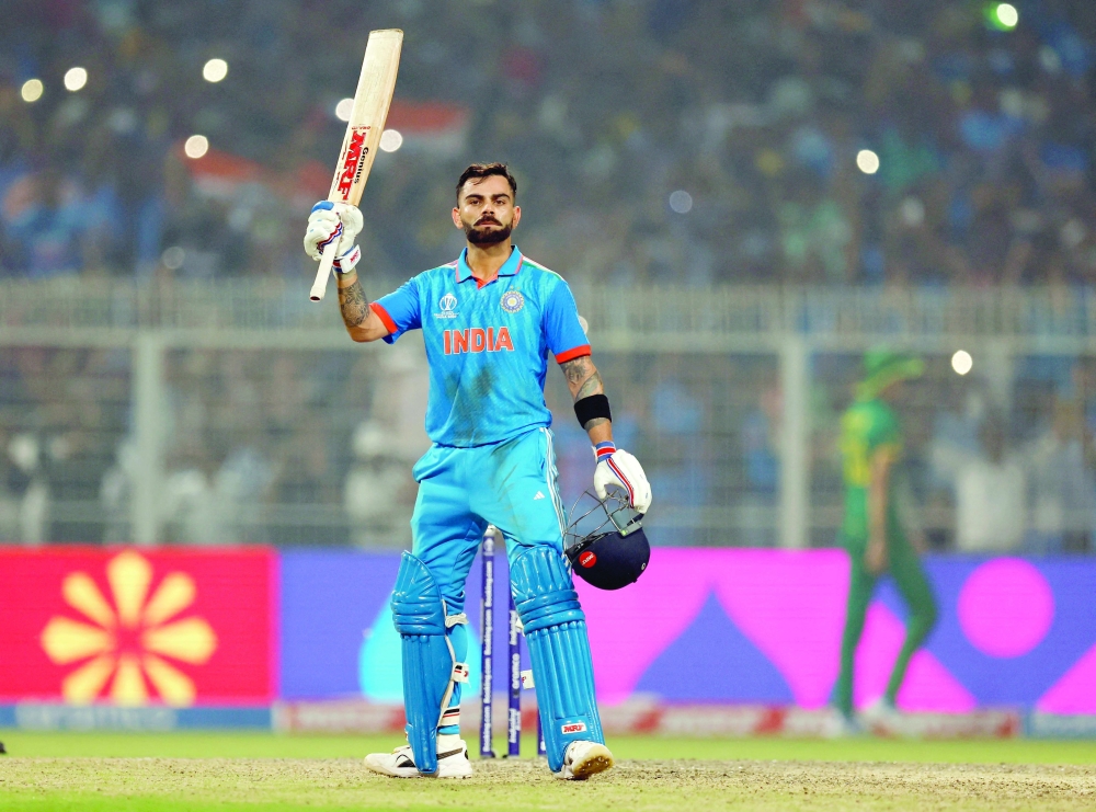 Virat Kohli celebrates after reaching his 49th century. — Reuters