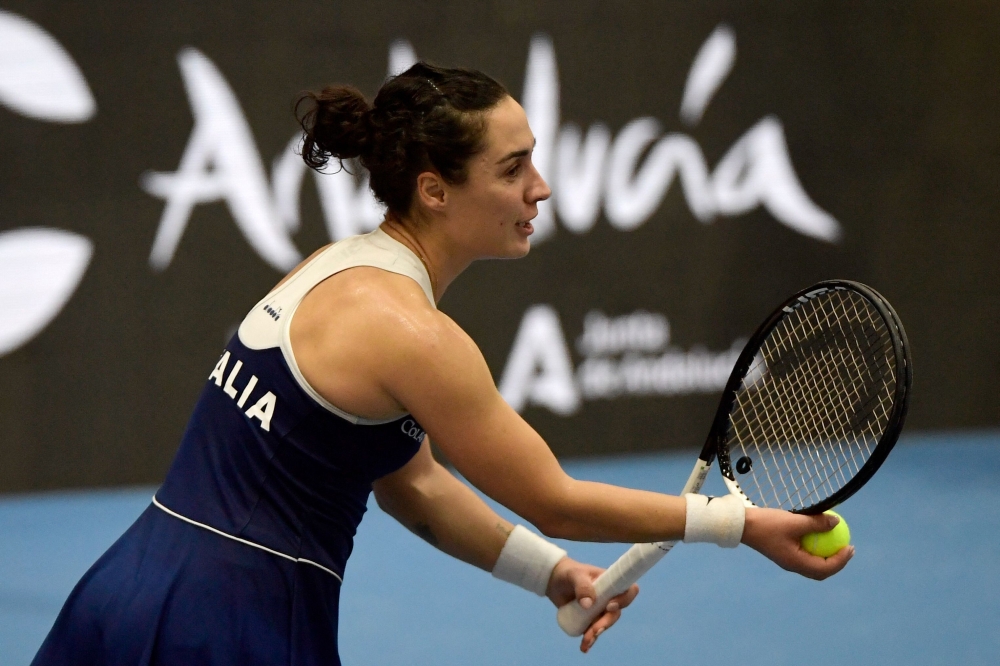 Italy's Martina Trevisan prepares to serve to Germany's Eva Lys during the group stage group B singles tennis match between Italy and Germany on the day 3 of the Billie Jean King Cup Finals 2023 in La Cartuja stadium in Seville on November 9, 2023. (Photo by CRISTINA QUICLER / AFP)

