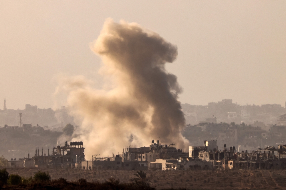 This picture shows smoke rising above buildings during an Israeli strike on the northern part of the Palestinian enclave, amid ongoing battles between Israel and the Hamas. - AFP

