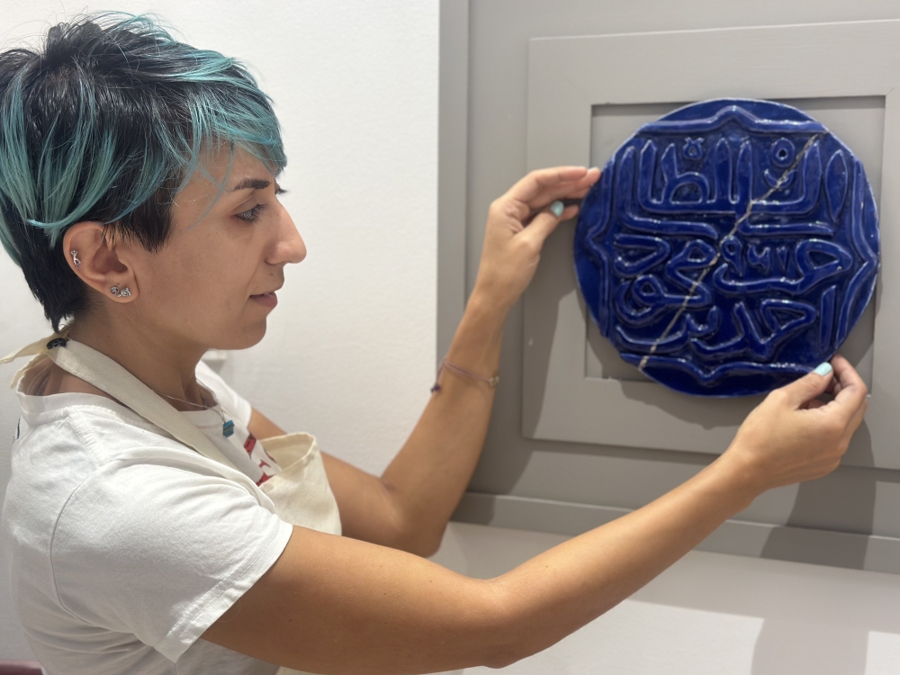 Shima displays a ceramic coin