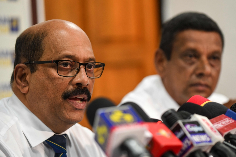 Acting secretary of Sri Lanka Cricket Chryshantha Kapuwatte (L) addresses a press conference at the Sri Lanka Cricket board office, in Colombo on November 8, 2023. Sri Lanka's Court of Appeal quashed the sports minister's decision to sack the country's crisis-ridden cricket board and restored the expelled officials on November 7, pending a full hearing. (Photo by Ishara S. KODIKARA / AFP)