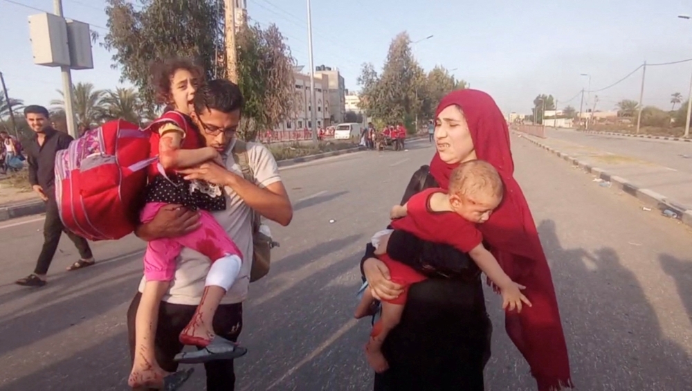 Palestinians fleeing north Gaza move southward, in the central Gaza Strip