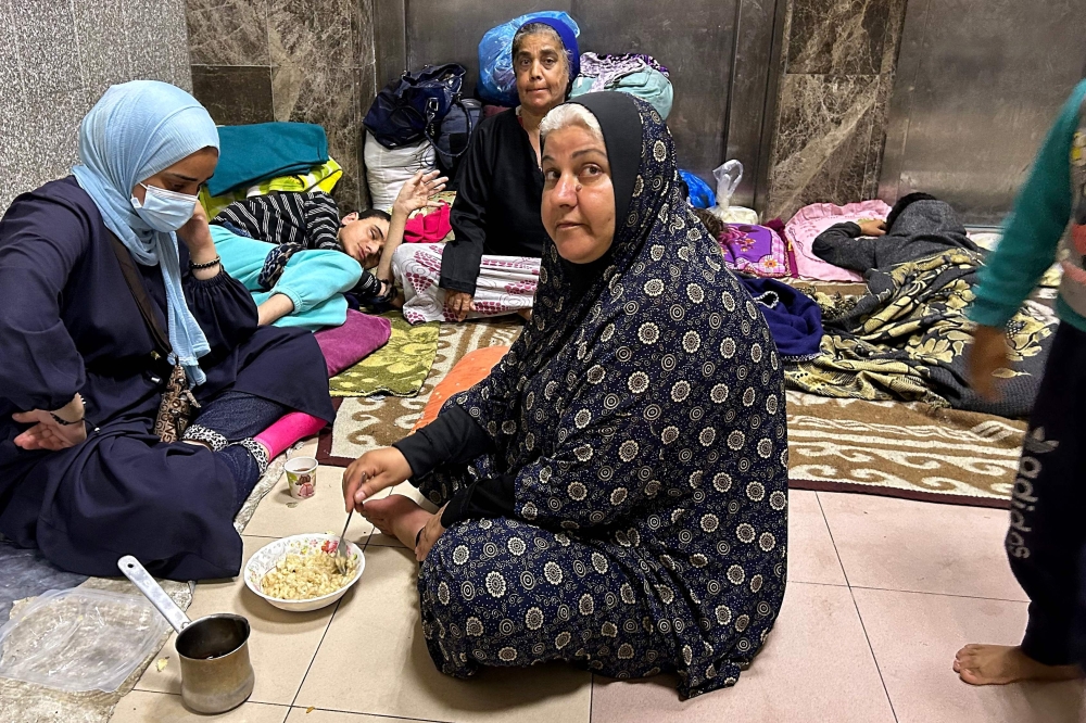 Internally displaced Palestinians are pictured at Al-Shifa hospital in Gaza City on November 10, 2023