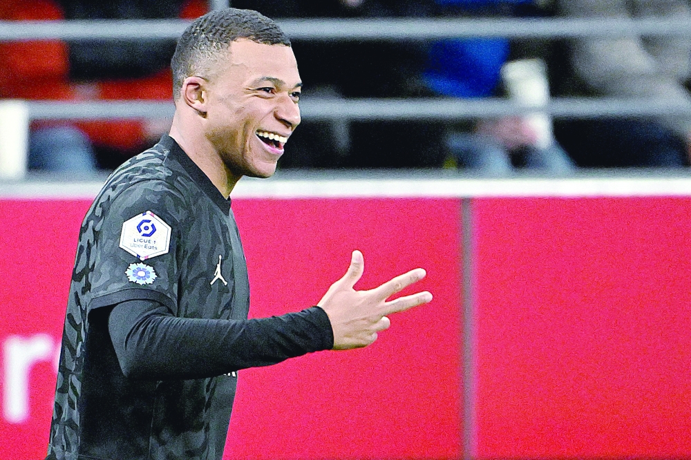 Kylian Mbappe celebrates after scoring his third goal. — AFP