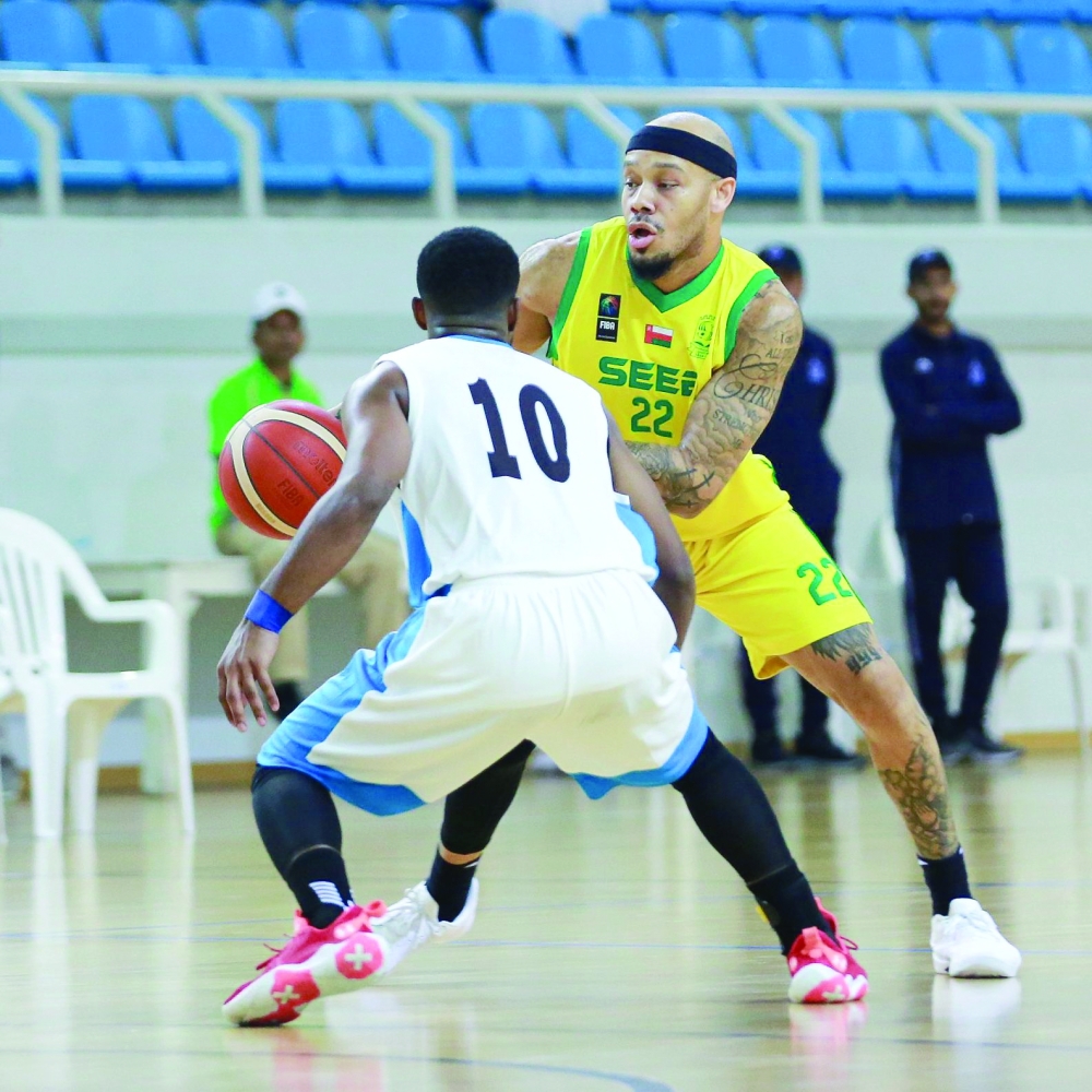 Al Seeb player tries to dodge Salalah player