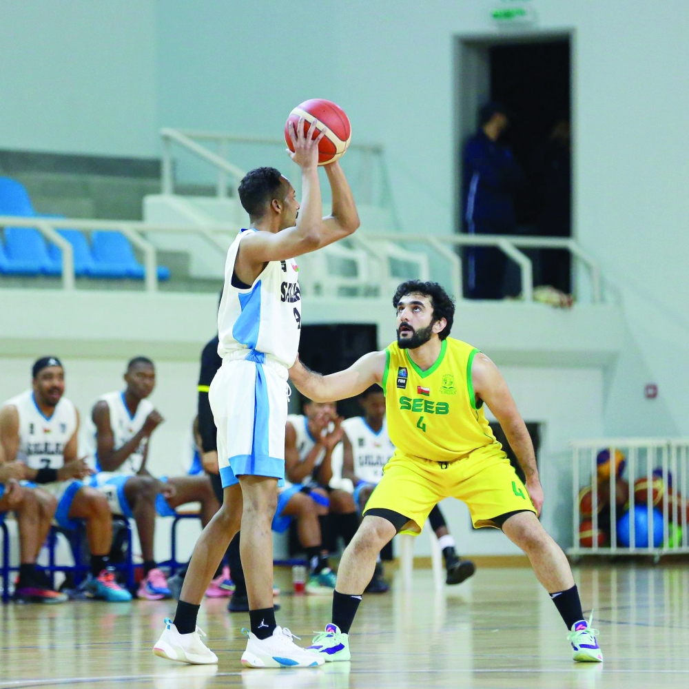 Al Seeb player tries to dodge Salalah player