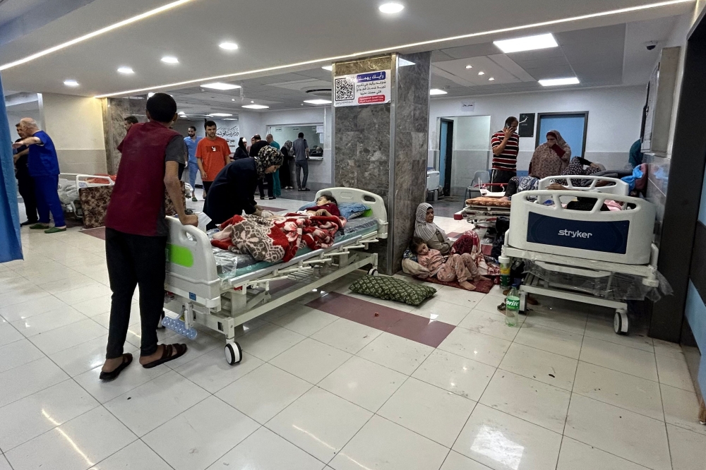 Medics and patients at Al-Shifa hospital in Gaza City 
