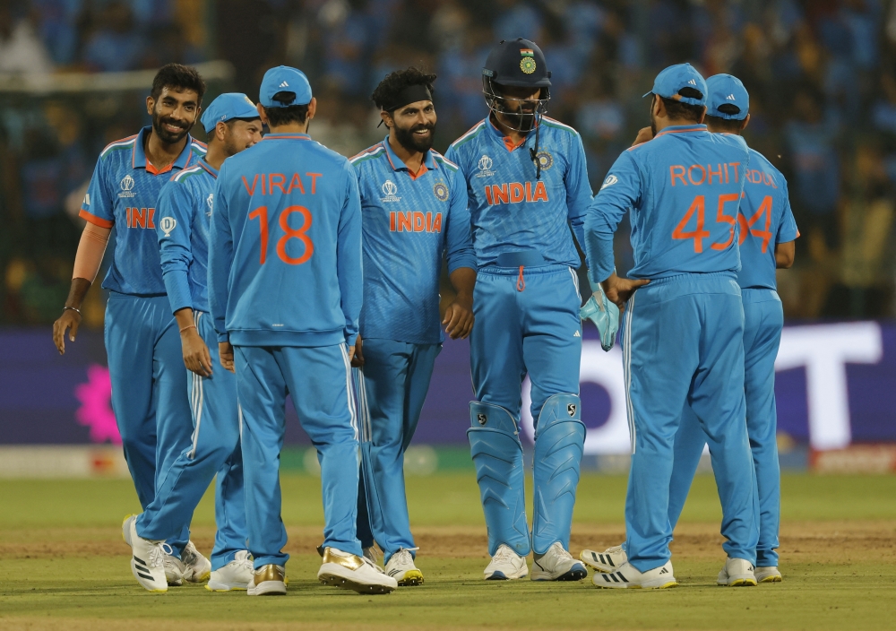Cricket - ICC Cricket World Cup 2023 - India v Netherlands - M. Chinnaswamy Stadium, Bengaluru, India - November 12, 2023  India's Ravindra Jadeja celebrates with teammates after taking the wicket of Netherlands' Max O'Dowd REUTERS/Adnan Abidi