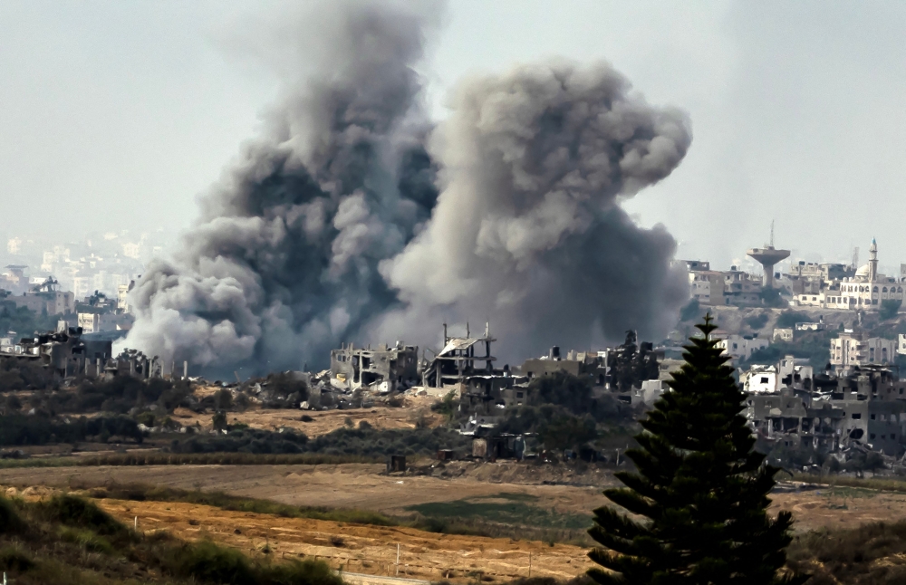 This picture taken on November 13, 2023 from a position along the border with the Gaza Strip in southern Israel shows a smoke plume erupting during Israeli bombardment on the Palestinian enclave amid ongoing battles. (Photo by FADEL SENNA / AFP)

