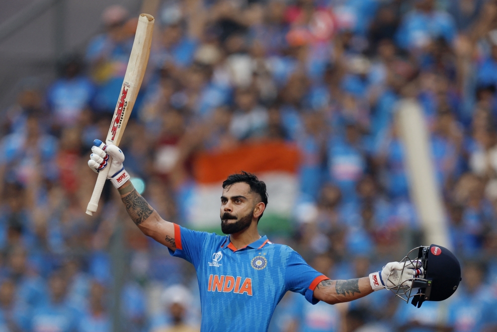 India's Virat Kohli celebrates after reaching his 50th century, breaking Sachin Tendulkar's record of most number of ODI centuries