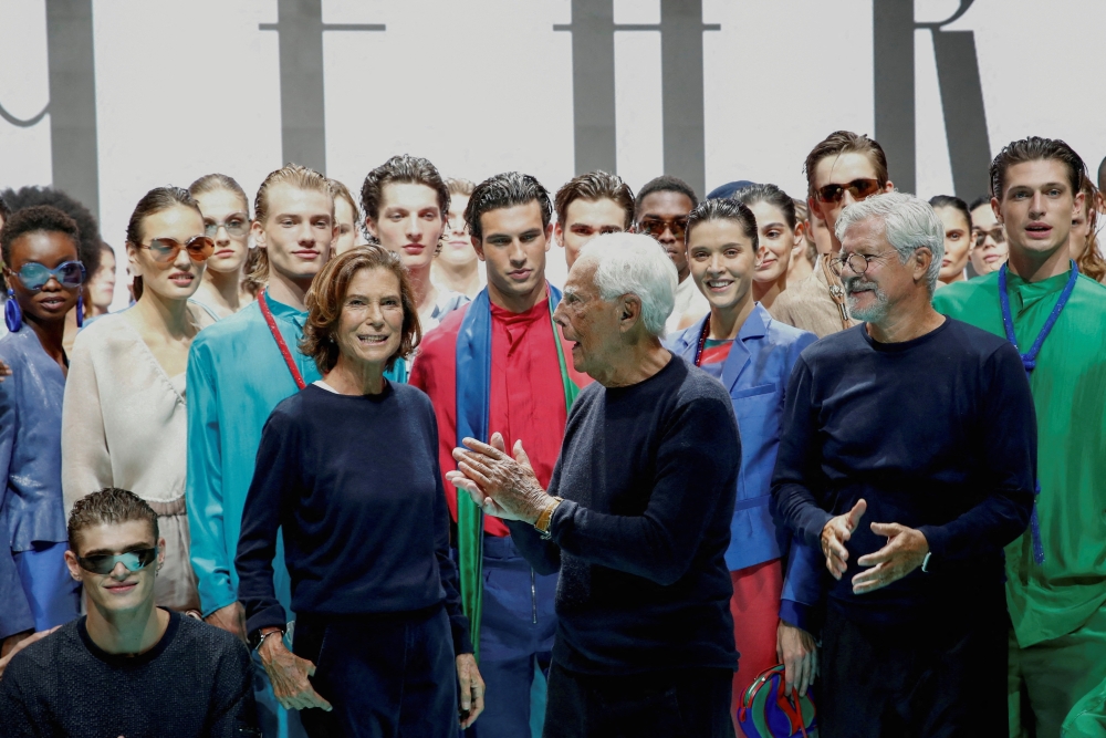 FILE PHOTO: Giorgio Armani, Silvana Armani and Pantaleo Dell'Orco pose with models after presenting the Emporio Armani Spring/Summer 2022 collection during Milan Fashion Week in Milan, Italy, September 23, 2021. REUTERS/Alessandro Garofalo/File Photo

