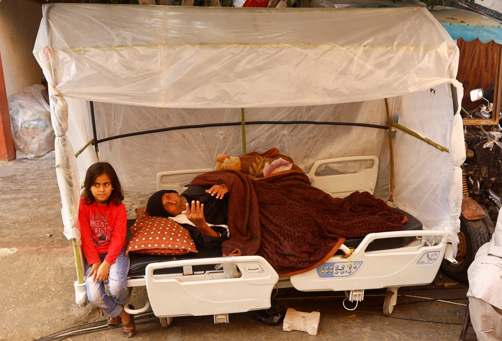 Palestinian patient Kamel Al-Najjar, 90, lies on a bed as he shelters in a makeshift tent outside Nasser hospital due to overcrowding, in Khan Younis in the southern Gaza Strip. — Reuters