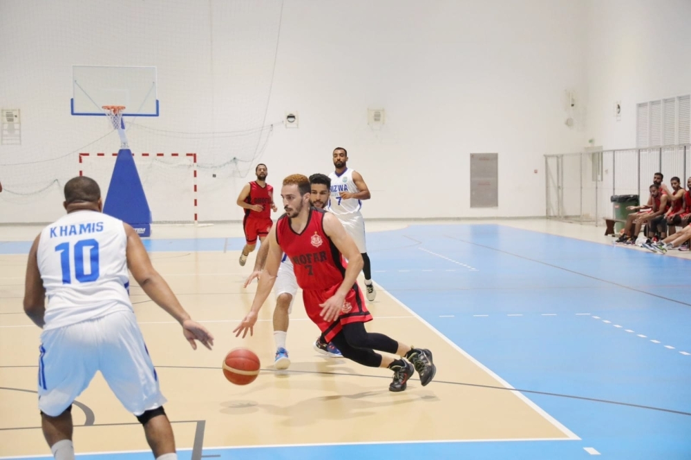 Dhofar player with the basket trying to passes Nizwa defebses