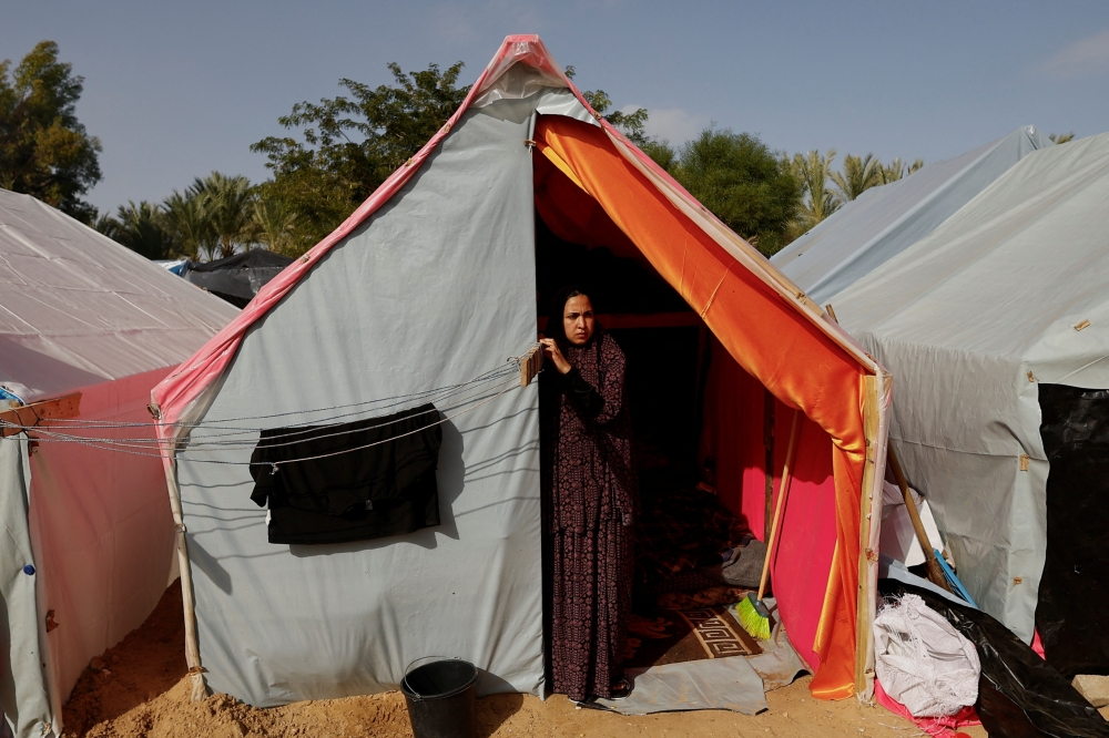 A woman looks on from inside a tent as displaced Palestinians, who fled their houses due to Israeli strikes, shelter in tents at Nasser hospital, in Khan Younis in the southern Gaza Strip.— Reuters