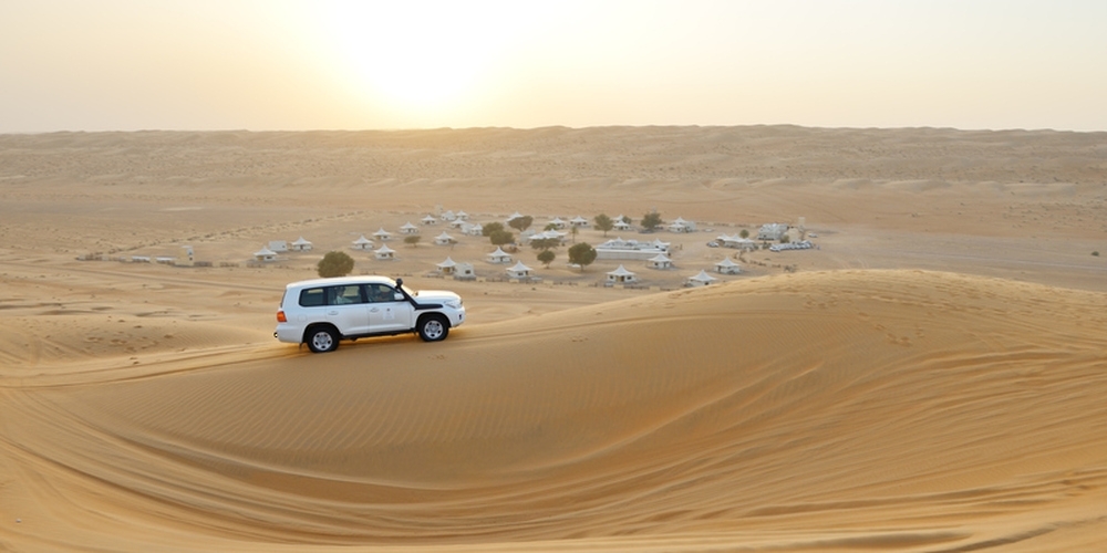 Image capturing the view of the vehicle in the desert by the camps, Sharqiyah Sands, Ash Sharqiyah, Oman