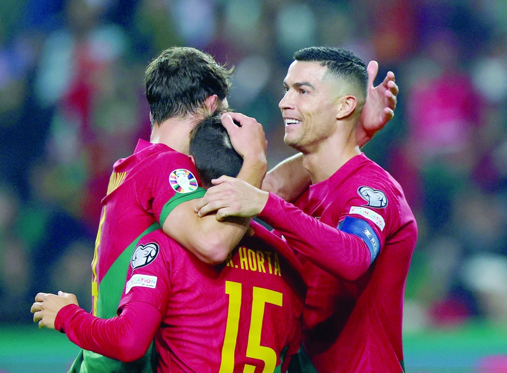 Portugal's Ricardo Horta celebrates scoring their second goal with Cristiano Ronaldo.— Reuters