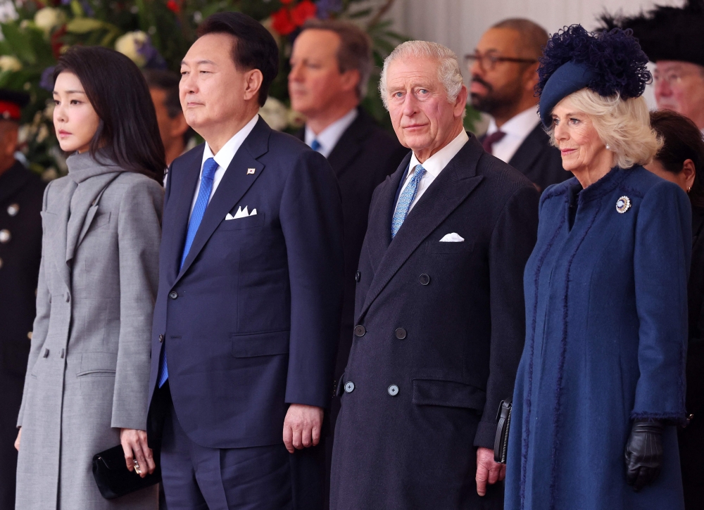 Britain's King Charles III and Britain's Queen Camilla stand with South Korea's President Yoon Suk Yeol and his wife Kim Keon Hee during a Ceremonial Welcome on Horse Guards Parade in central London on the first day of a three-day state visit to the UK. - AFP